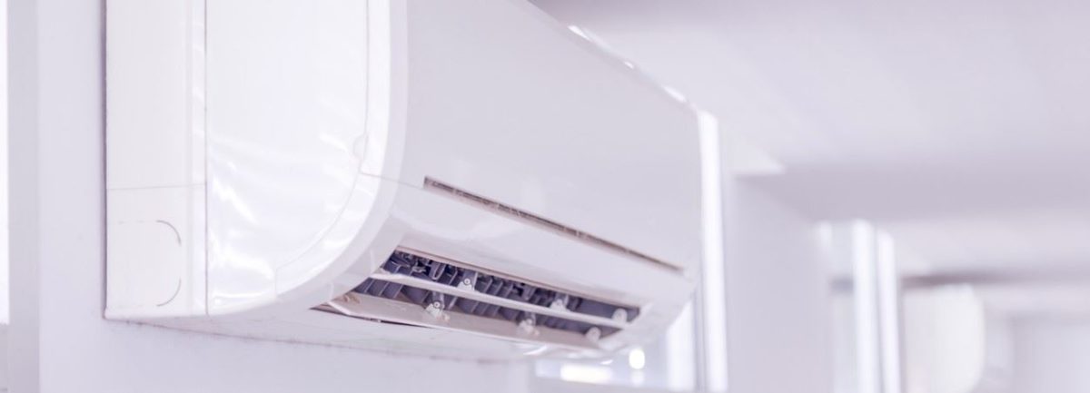 An air handler for a ductless mini-split is mounted to the wall.