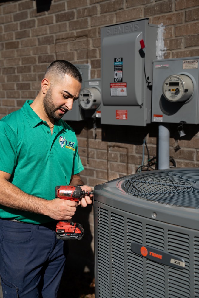 LEX HVAC technician repairing system in Plano, TX