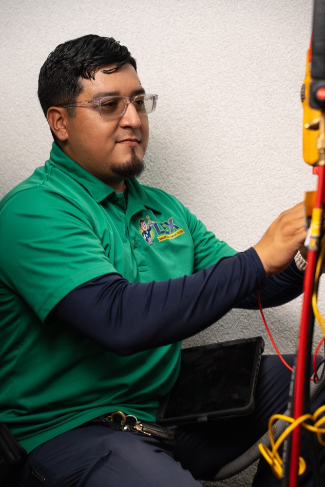 LEX HVAC technician repairing system in Plano, TX