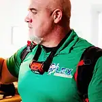 %Imagetitle% | Lex Cooling, Heating Plumbing &Amp; Electrical A man in a green work shirt adjusts a wall-mounted digital thermostat set to 70 degrees.